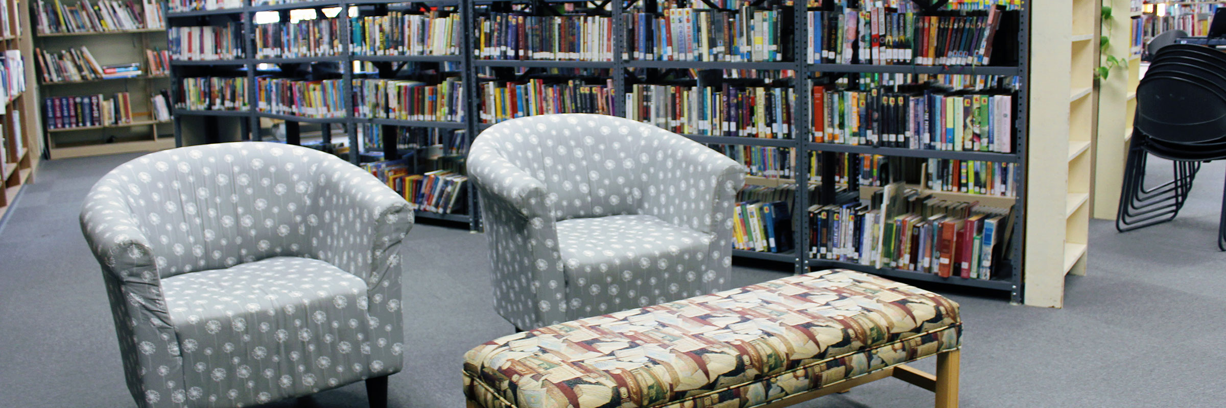 Chairs in front of shelves of books inside the Dufur School Library